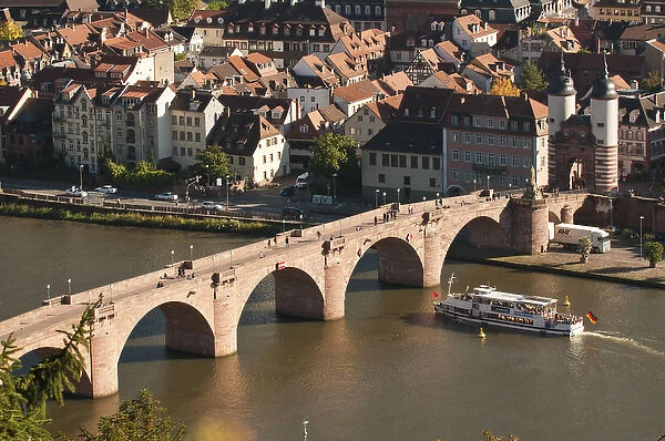 View of tour boat passing under the Alte Brucke or Old Bridge, Neckar River Heidelberg Castle