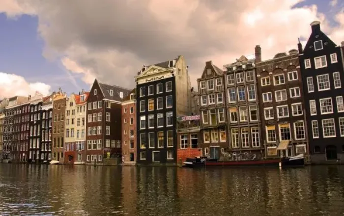 Framed Print : View of the unique architecture and gabled homes and coffee shop along a colorful canal