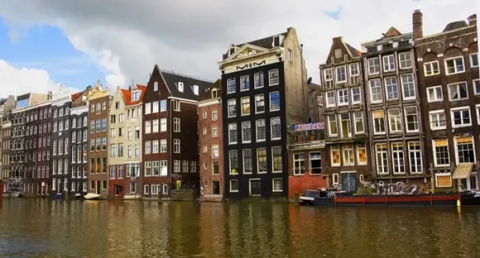 Framed Print : View of the unique architecture and gabled homes and coffee shop along a colorful canal