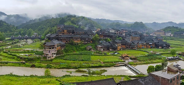Village with farmland in morning mist, Chengyang, Sanjiang, Guangxi Province, China