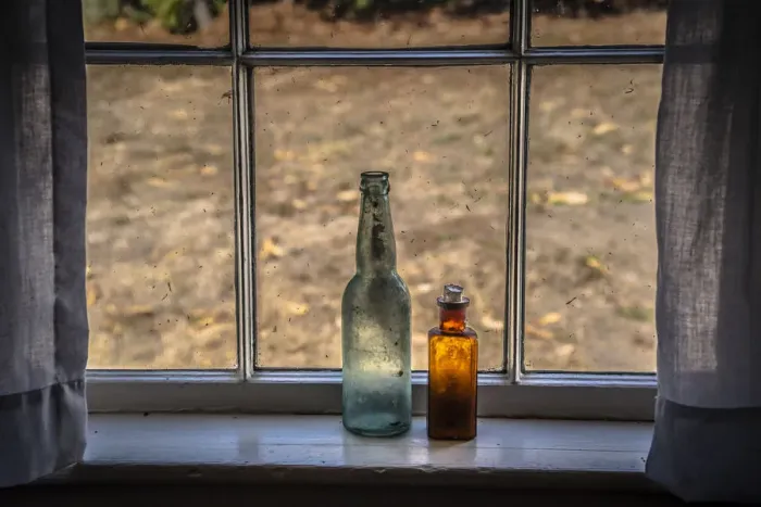 Framed Print : Two vintage bottles on window sill