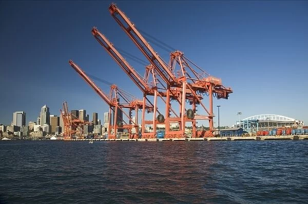 WA, Seattle, Seattle skyline with shipping cranes from Elliott Bay