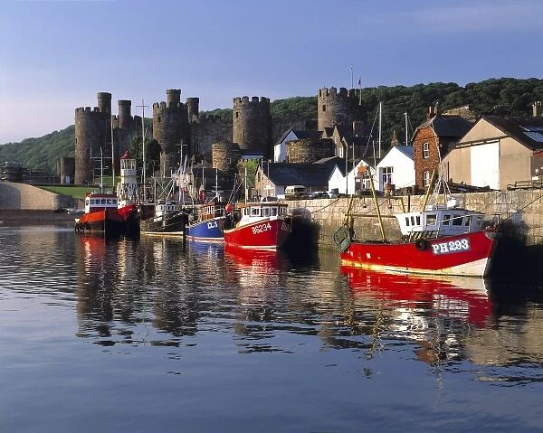 Wales, Conwy Co. Conwy. Fishing boats reflect iin the peaceful arbor near the Castle in Conwy