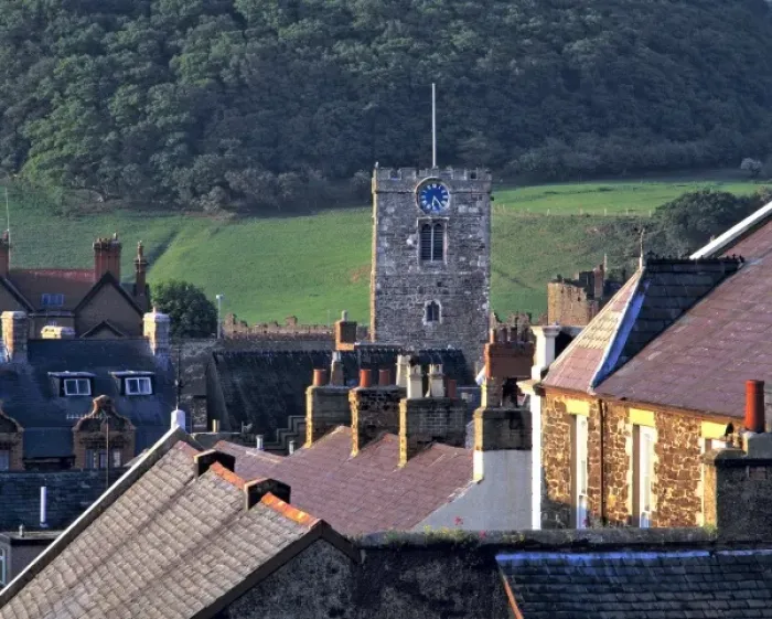 Framed Print : Wales, Conwy Co. Conwy. The sun highlights the steep roofs and the Clock Tower in Conwy, Conwy Co