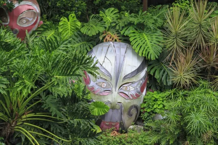 Framed Print : warrior masks in lush green tropical foliage, Lichi Bay Walkway and Park, Guangzhou