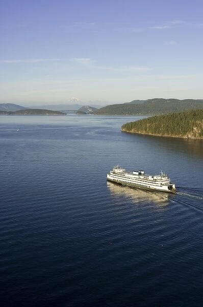 The Washington State ferry Hyak passing by Shaw Island in the evening light with Mt