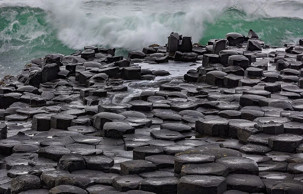 Waves crashing into basalt at the Giants Causeway in County Antrim, Northern