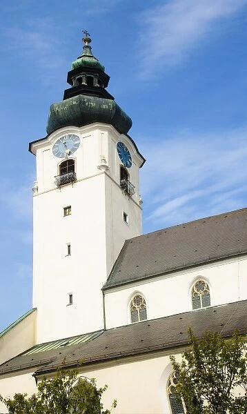 Wels, Upper Austria, Austria - Low angle view of a clock and bell tower of an old church