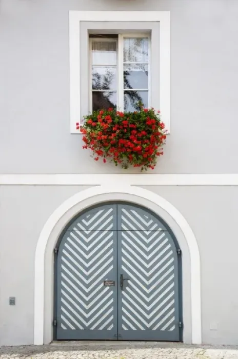 Framed Print : Wels, Upper Austria, Austria - Red flowers are hanging from an open window over a