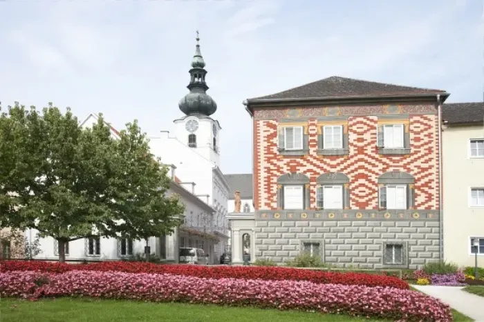 Framed Print : Wels, Upper Austria, Austria - Rows of red and pink flowers border a lawn in front of a building