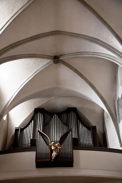 Wels, Upper Austria, Austria - A statue of an angel is in front of a pipe organ s