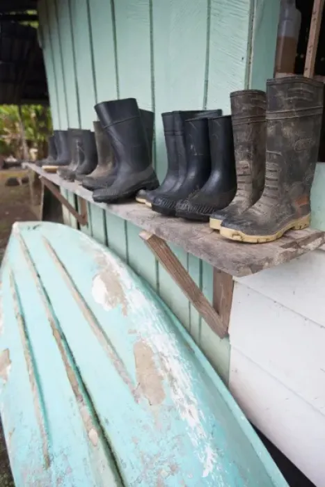 Framed Print : Wet season supplies including rubber boots, canoes and oars line a shed at Sirena Framed Print : Wet season supplies including rubber boots, canoes and oars line a shed at Sirena