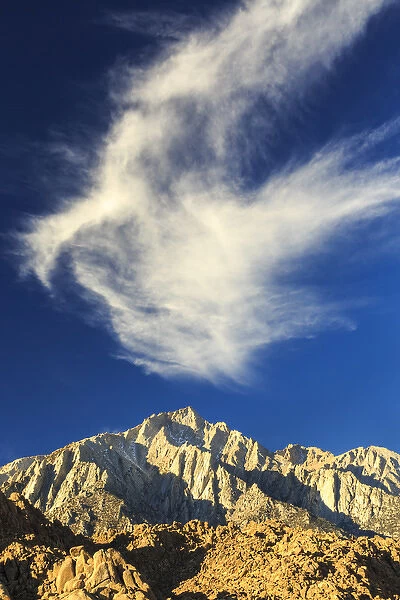 Whispy white clouds and dark blue sky above Lone Pine Peak, California