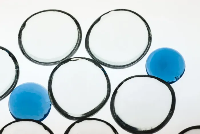 Framed Print : White and Blue glass pebbles with light
