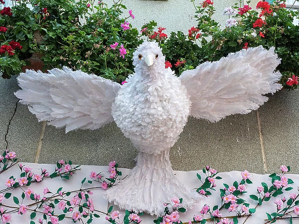 A white dove made of feathers, symbolizing the Holy Spirit. Festa dos Tabuleiros is one of the most important celebrations in Portugal
