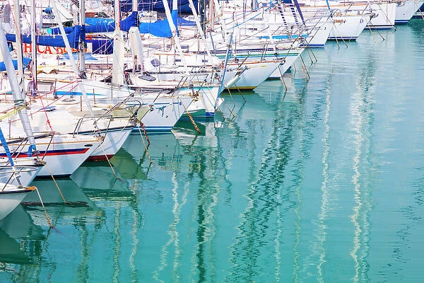 White sailboats in blue water