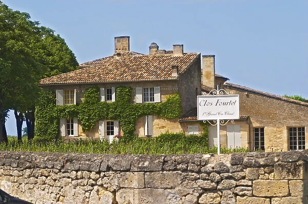 A white sign saying Clos Fourtet 1er premier first Grand Cru Classe and the chateau building itself