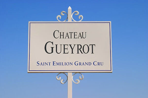 A white sign in the vineyard saying Chateau Gueyrot Saint Emilion Grand Cru Saint
