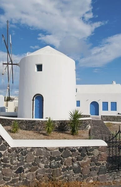 White windmill house in town in valley of Fira in Santorina Greece in Greek Islands