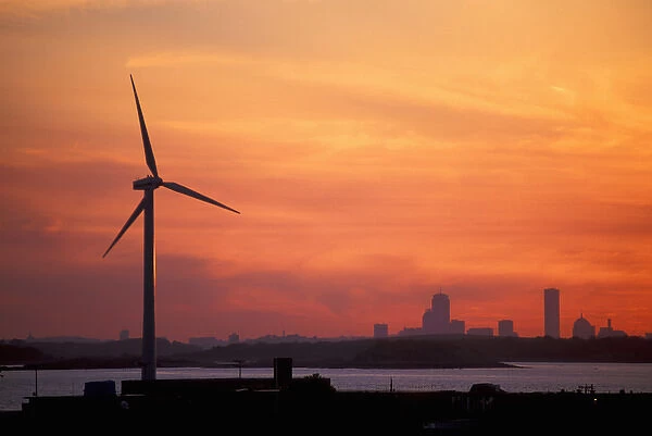 Wind Turbine in Hull, Massachusetts. The Boston skyline is in the distance. Sunset