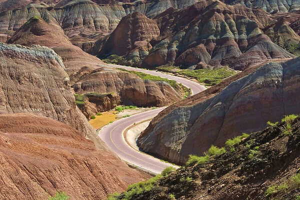 A winding road through the colorful mountains in Zhangye National Geopark