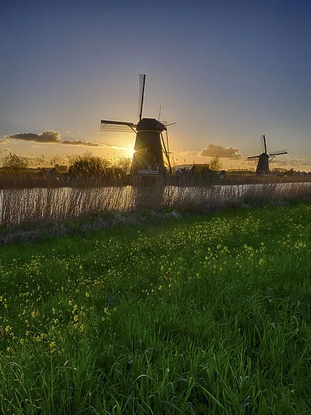 Windmill along the canal at sunset