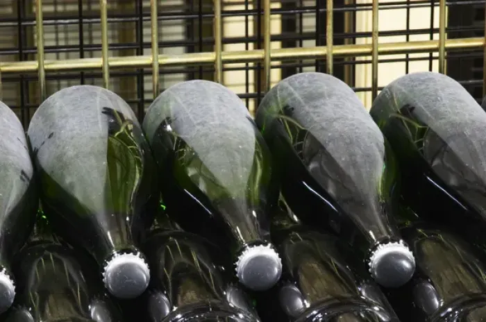 Framed Print : Wine Bottles of champagne resting horizontally on the side undergoing secondary fermentation Framed Print : Wine Bottles of champagne resting horizontally on the side undergoing secondary fermentation