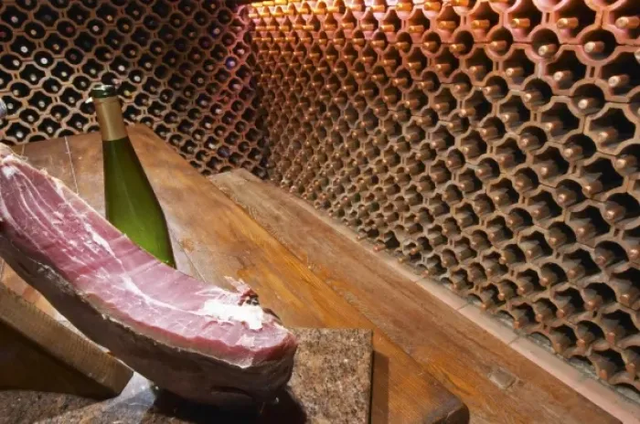 Framed Print : The wine cellar and tasting room, walls are lined with bottles stacked in terracotta