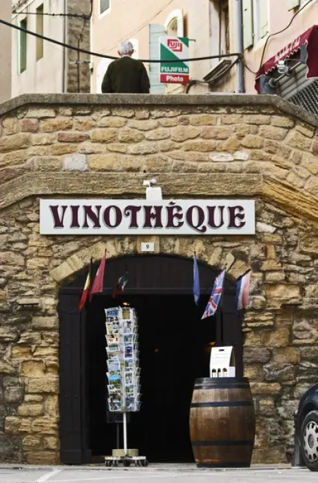 Framed Print : A wine shop vinotheque with flags, post cards on a stand and a barrel with wine bottles Framed Print : A wine shop vinotheque with flags, post cards on a stand and a barrel with wine bottles