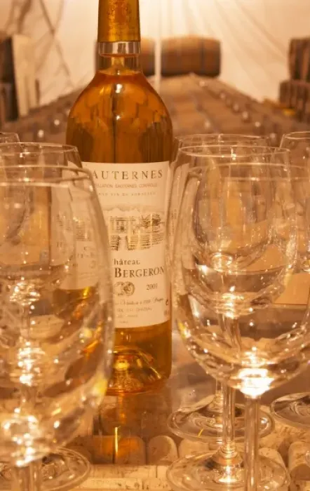 Framed Print : Wine tasting in the cellar, glasses, a bottle and barrels in the background - Chateau Haut Bergeron