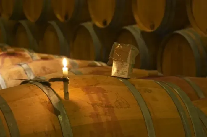 Framed Print : The winery, barrel aging cellar: a burning candle, a box of sulphur pellets - Chateau