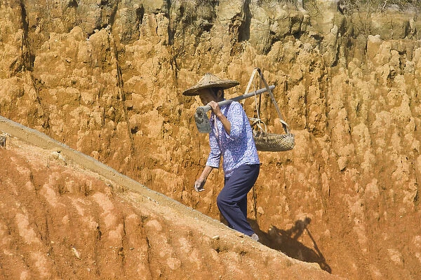 Woman carrying basket on clay hill, Yongding, Fujian, China (MR)