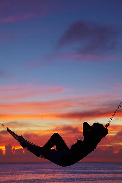 Woman in hammock at sunset, Coral Coast, Viti Levu, Fiji, South Pacific (MR)
