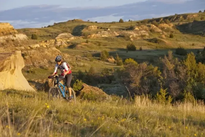 Framed Print : Woman mountain bikes on the Maah Daah Hey Trail near Medora North Dakota (MR)