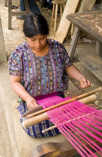 Woman weaving fabrics in small village outside of Antigua Guatemala in Central America