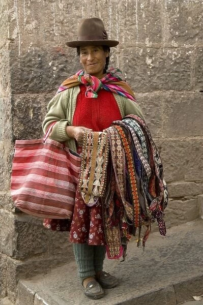 Woman with weavings to sell, Cuzco, Peru. (MR)