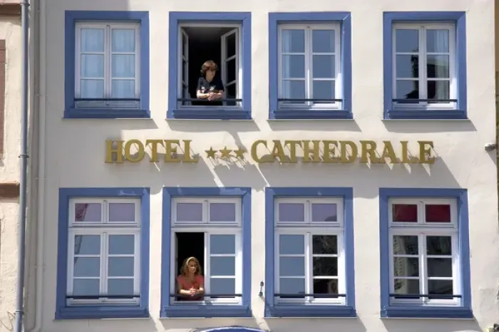 Framed Print : Women looking out the window of the Cathedral Hotel at Strasbourg, France Framed Print : Women looking out the window of the Cathedral Hotel at Strasbourg, France