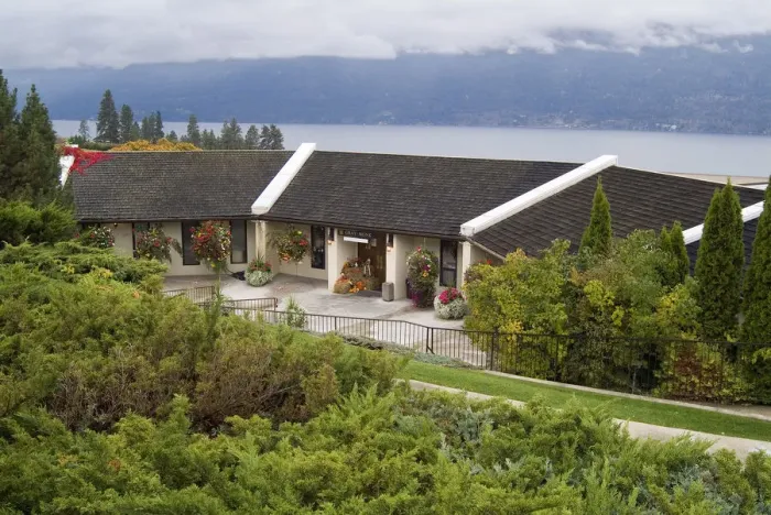 Framed Print : The wood-shingle roofed Grey Monk Estate Winery sits on the steep hills that slope Framed Print : The wood-shingle roofed Grey Monk Estate Winery sits on the steep hills that slope