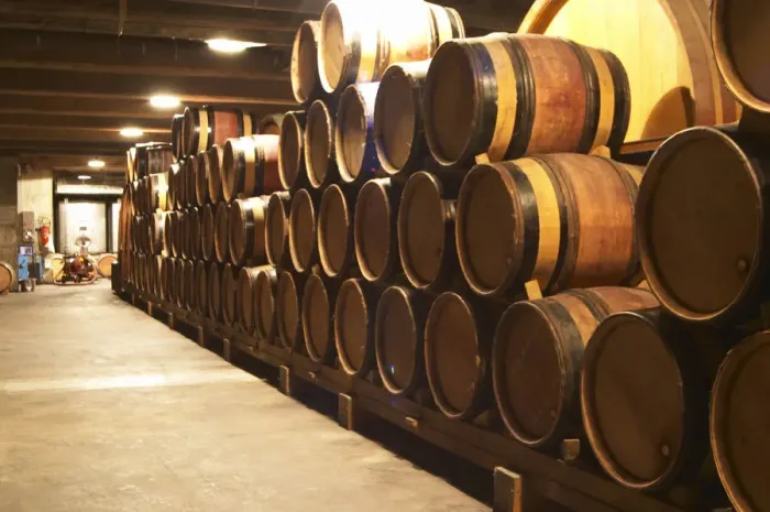 Framed Print : Wooden barrels with aging wine in the cellar of Guigal in Ampuis. Domaine E Guigal