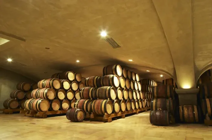 Framed Print : Wooden barrels with aging wine in the cellar of Guigal in Ampuis. The vaulted roof