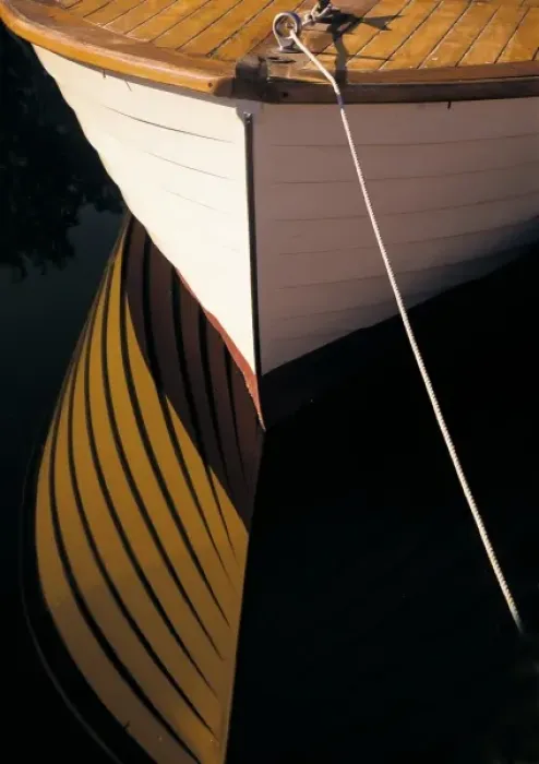 Framed Print : Wooden boat reflection on still water Framed Print : Wooden boat reflection on still water
