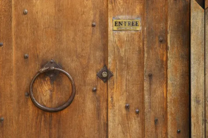Framed Print : The wooden entrance door with metal ring knocker and old lock, sign saying entree, step in Framed Print : The wooden entrance door with metal ring knocker and old lock, sign saying entree, step in
