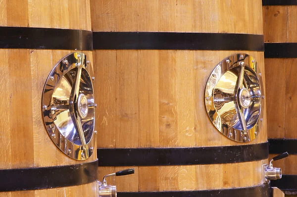 Detail of wooden fermentation tanks vats with a polished stainless steel door, Maison Louis Jadot