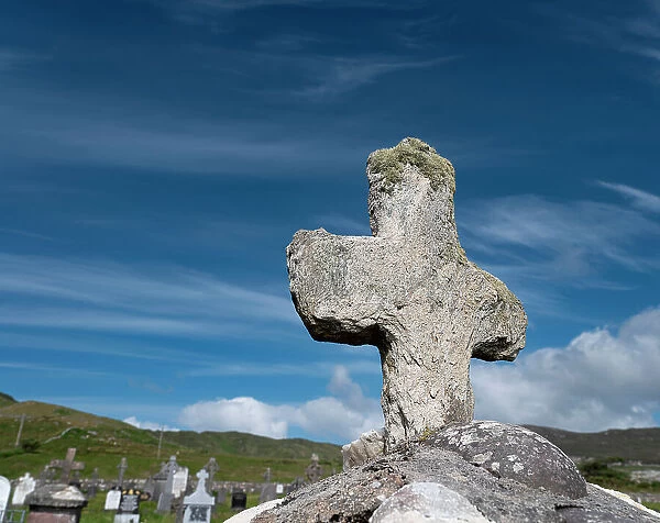 Worn stone cross adorns a grave in Kildavnet, Achill Island, County Mayo, Ireland