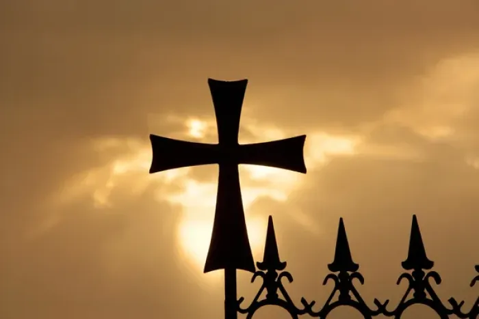 Framed Print : A wrought-iron cross on a fence in Syria at sunrise
