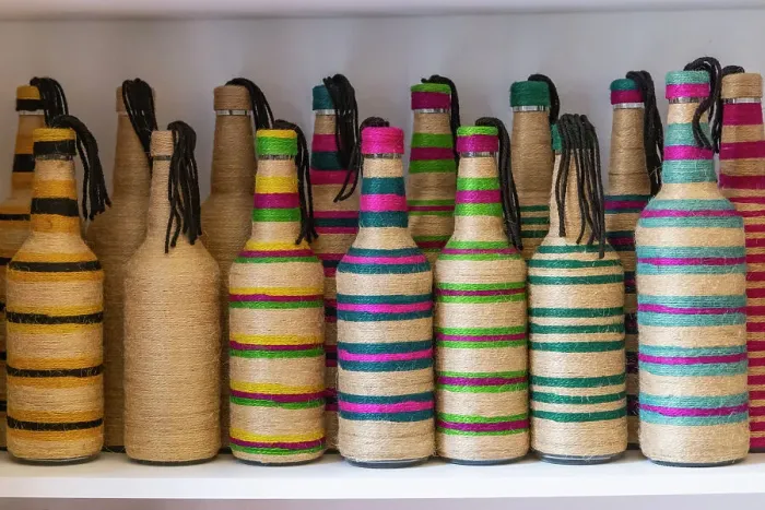 Framed Print : Yasmine Hammamet, Nabeul, Tunisia. Bottles decorated with colored string at a artisan crafts market in Tunisia