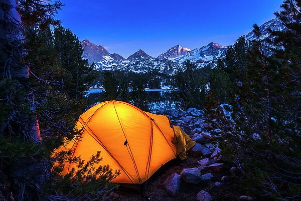 Yellow dome tent glowing at night in Little Lakes Valley, John Muir Wilderness, California, USA