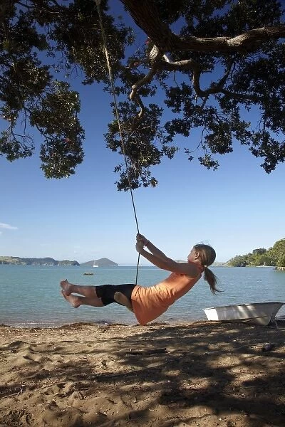 Young Girl on Rope Swing under Pohutukawa Tree, Oamaru Bay, Coromandel, North Island