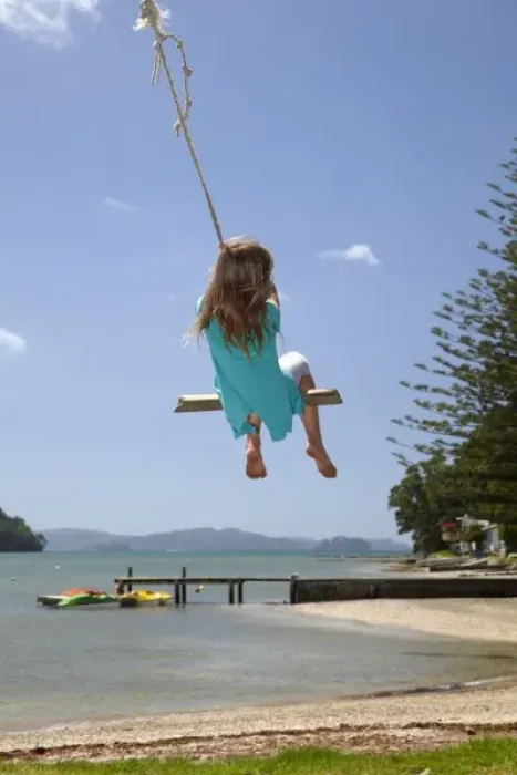 Framed Print : Young girl on rope swing, Sandspit, near Warkworth, Auckland Region, North Island