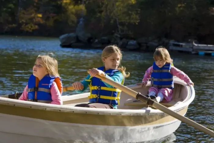 Framed Print : Three young girls (ages 3, 5, 9) in a row boat at Oliver Lodge on Lake Winnipesauke in Meredith